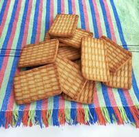 Wheat biscuits in the steel plate with white background. Indian biscuits popularly known as Chai biscuit in India. Glucose biscuit plate photo