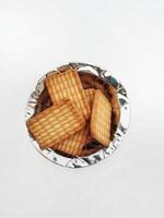 Wheat biscuits in the steel plate with white background. Indian biscuits popularly known as Chai biscuit in India photo