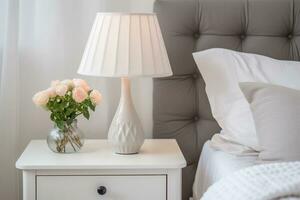 AI generated Lamp and flowers on white nightstand in the bedroom. Home interior in Scandinavian style. AI generated. photo