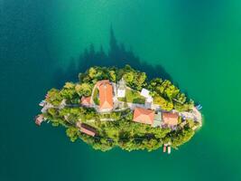 Old church standing on the island in the middle of Bled lake photo