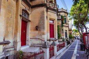 Beautiful building with red window shutters photo