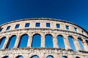 Pula Arena facade with blue sky on the background photo
