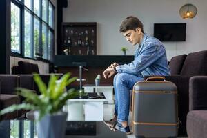 Caucasian traveller is waiting in airline business departure lounge terminal waiting for boarding airplane photo