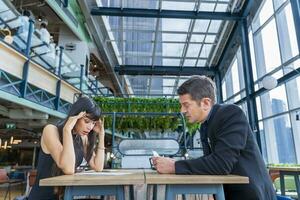 Executive manager is showing bad financial annual report to his colleague in the meeting with serious loss and debt on investment for business strategy management concept photo