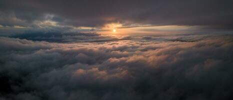 Panorama shot of colorful light of sunrise over rainforest mountains with fog and cloud inversion for natural cinematic of national park and wildlife reserve area photo