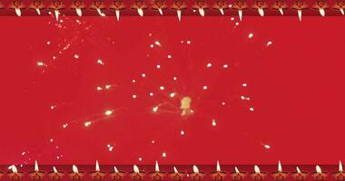 contento Diwali movimento grafico animazione sfondo con in movimento olio lampada e che esplode fuochi d'artificio bokeh effetto nel il mezzo. video