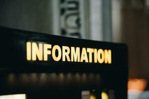 Close up information sign with back light of white and yellow colour photo