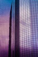 Close up shot of office windows in the skyscraper mirroring the cloudy sky photo