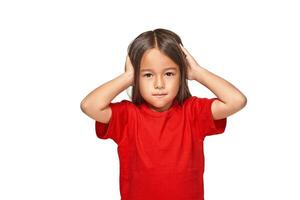 Little girl closed her ears with hands and does not want to listen anyone photo