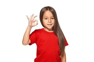 Girl showing positive sign on natural background photo