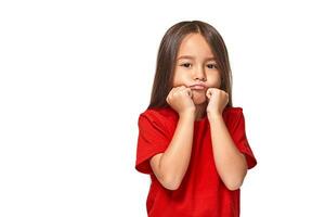 Girl in red t-shirt serious face offended white background photo