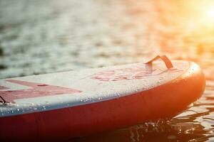 Close up of a stand up paddle board SUP and paddle on a dock photo
