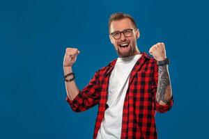 Emotional and people concept young bearded man in checkered shirt. Hipster style. Winner photo