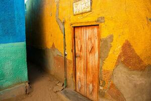 Colourful exterior wall of a Nubian house in Egypt. Typical African village houses facade. Medieval street. photo