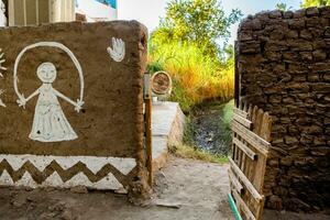 Colourful exterior wall of a Nubian house in Egypt. Typical African village houses facade. Medieval street. photo