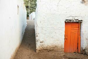 Colourful exterior wall of a Nubian house in Egypt. Typical African village houses facade. Medieval street. photo