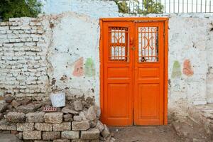 Colourful exterior wall of a Nubian house in Egypt. Typical African village houses facade. Medieval street. photo