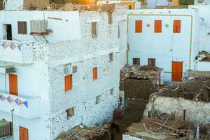 Colourful exterior wall of a Nubian house in Egypt. Typical African village houses facade. Medieval street. photo