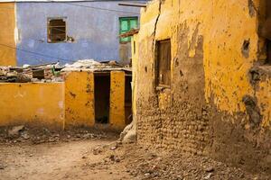 Colourful exterior wall of a Nubian house in Egypt. Typical African village houses facade. Medieval street. photo