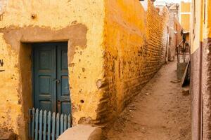 Colourful exterior wall of a Nubian house in Egypt. Typical African village houses facade. Medieval street. photo