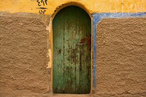 Colourful exterior wall of a Nubian house in Egypt. Typical African village houses facade. Medieval street. photo