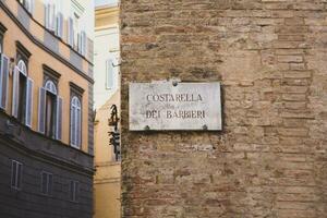 Beautiful colored and medieval street in the old town of Siena, Italy photo