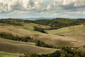 Famous Tuscany landscape with curved road and cypress, Italy, Europe. Rural farm, cypress trees, green field, sunlight and cloud. photo