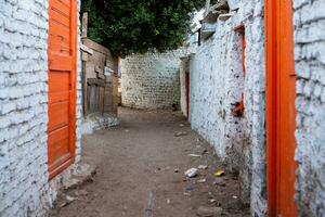 Colourful exterior wall of a Nubian house in Egypt. Typical African village houses facade. Medieval street. photo