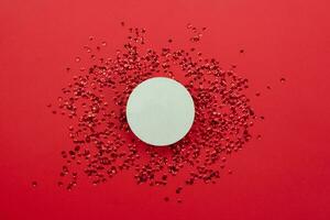 Wooden circle on red background. Copy space. photo