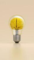 Light bulb with a brain inside illuminated on yellow background. Innovation concept. photo