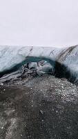 Vatnajokull glacier hiking inside caves, icelandic ice cap forming magical icebergs with blue transparent chunks. Wintry frozen glaciers with covered frost structure, climate change. photo