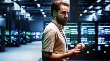 Engineer in data center using renewable solar and wind energy sources to power crypto mining operations. Expert working with eco friendly server clusters preventing significant environmental impact photo