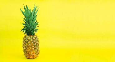 Ripe pineapple on a yellow background. Copy space. photo