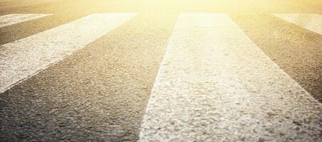 Sunrise on the asphalt road. The road on the background of the sunset. photo