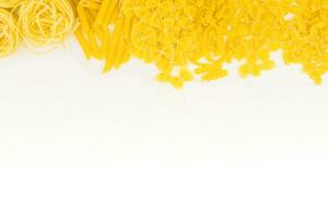 Different types of pasta on a white background. Raw macaroni. photo