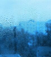 Natural drops of water on window glass photo