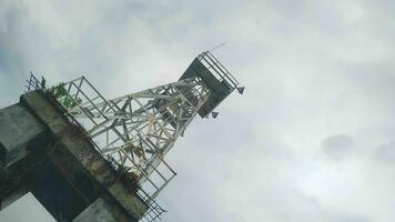 light tower in the middle of the sea with a sky background photo