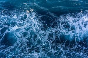 Seascape from high perspective. Top view of ocean sea water splashing. photo