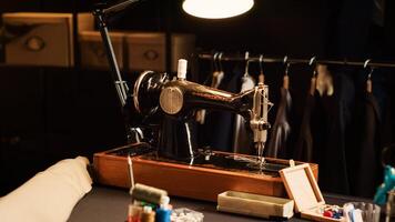 Old school sewing machine in atelier, fashion industry with tailoring tools used to create custom made clothing line. Textile industry with professional instruments and workstations. Close up. photo