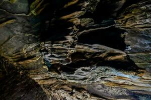 the inside of a cave with a large rock formation photo