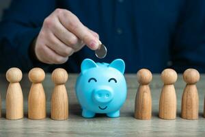 A man puts a coin in a piggy bank among people. Political purses wallets and concealment of financial fortunes through third parties. Collection of donations. Accumulating money. Savings photo