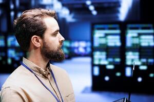 Close up shot of precise engineer doing inspection in blockchain technology application specific integrated circuit server hub. Adept technician working in crypto mining facility photo