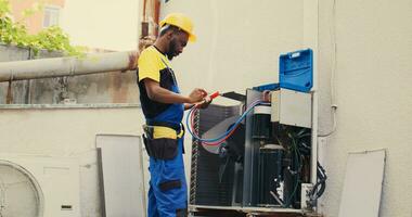 Skillful serviceman calibrating set of barometer meters during comissioned condenser analysis. Precise professional looking for potential high pressure in hvac system cooling system, close up photo