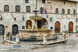 Fountain of three lions, landmark in Assisi, Italy photo