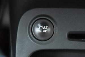 Car interior with closeup of engine start stop system button photo
