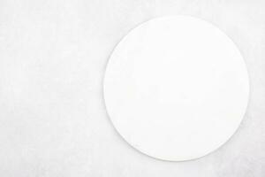 Marble round cutting board flat lay mockup on gray concrete stone background. Top view. Copy space. photo