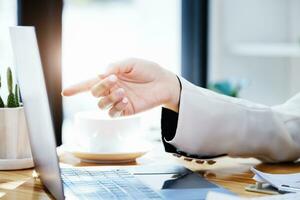 Investment concepts, businesswomen use document and computers to analyze stock markets, quantitative data collection, financial statement analysis, profitability through internet technology. photo