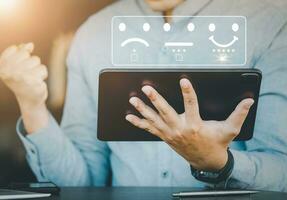 The concept of satisfaction rating, evaluation results, quality of work, male employees express their happiness after receiving a 5-star smiley face icon image from the company they work for. photo
