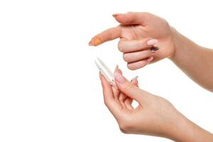 Contact eye lens. Close-up of woman holding white eye lense on finger. photo