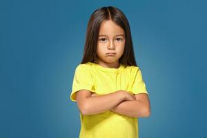 Angry little kid showing frustration and disagreement photo